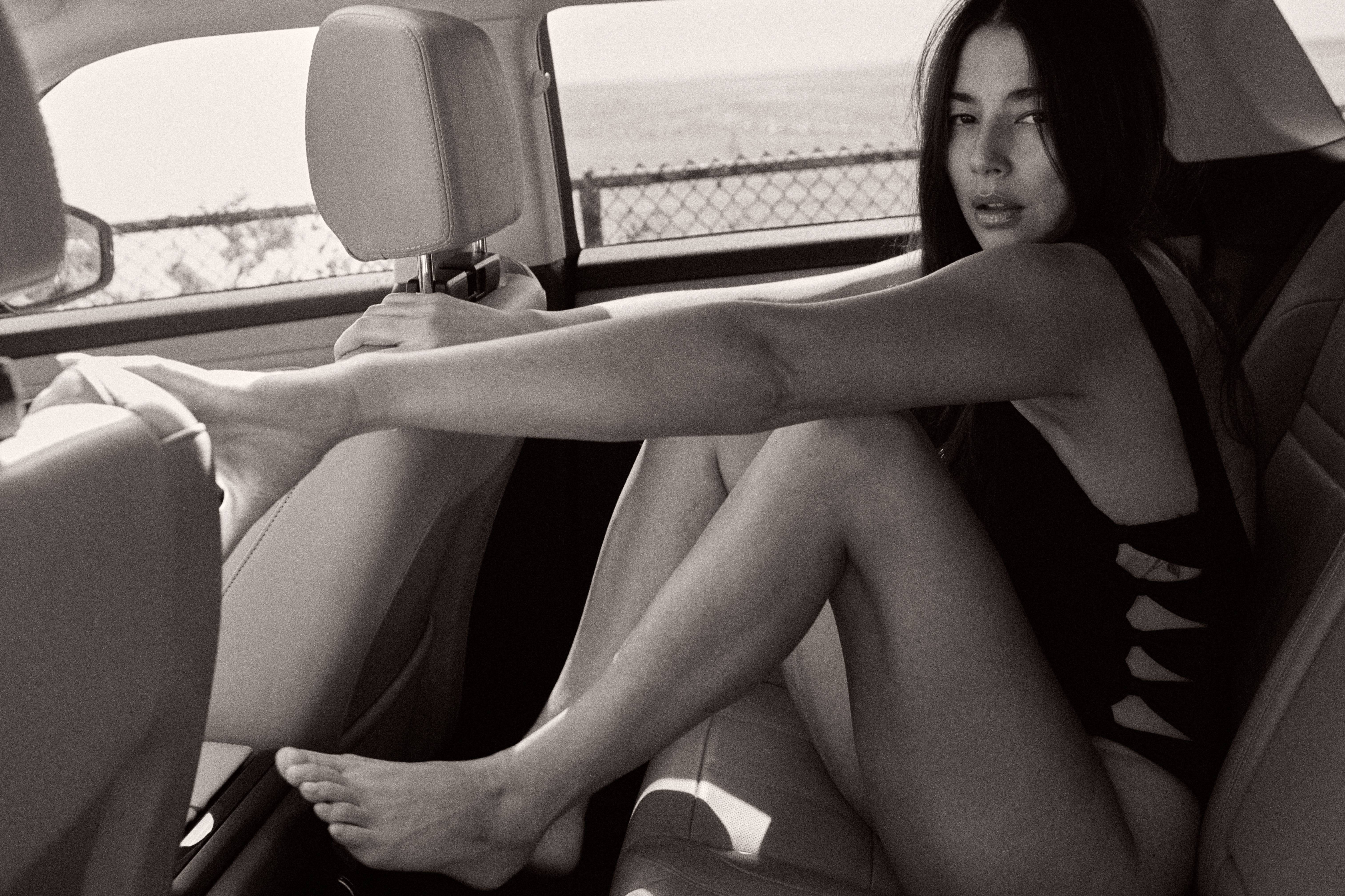 Model in car backseat