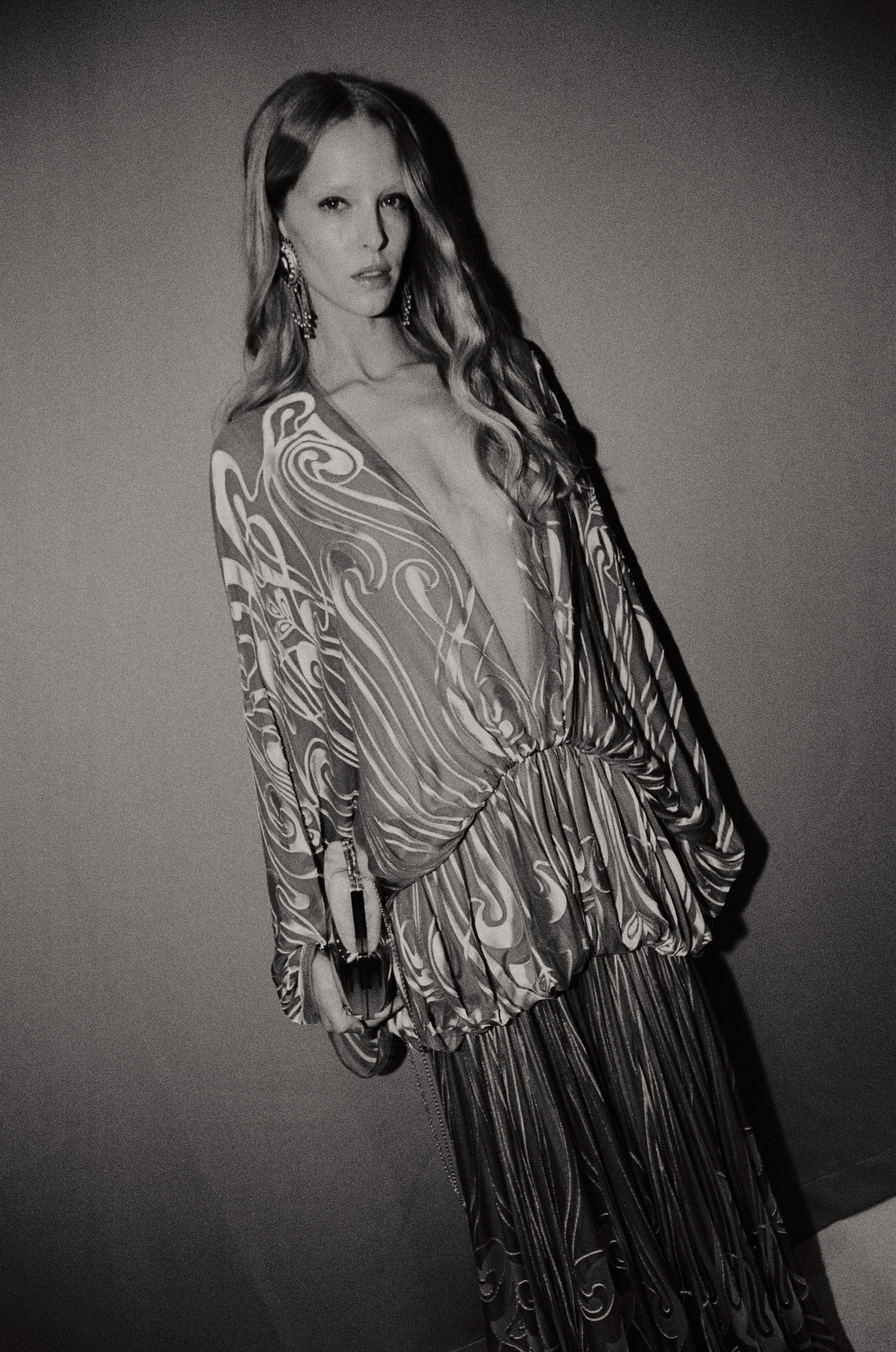 Model in swirl-patterned plunging dress