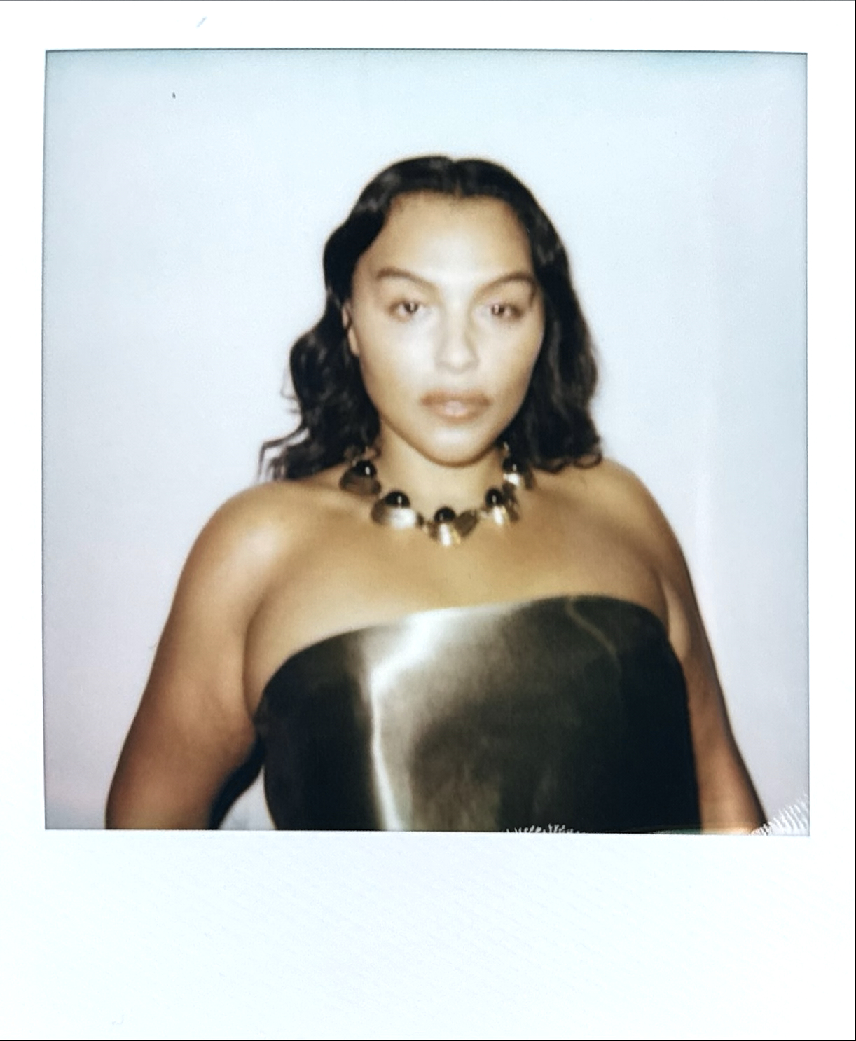 Polaroid model in gold metallic bustier