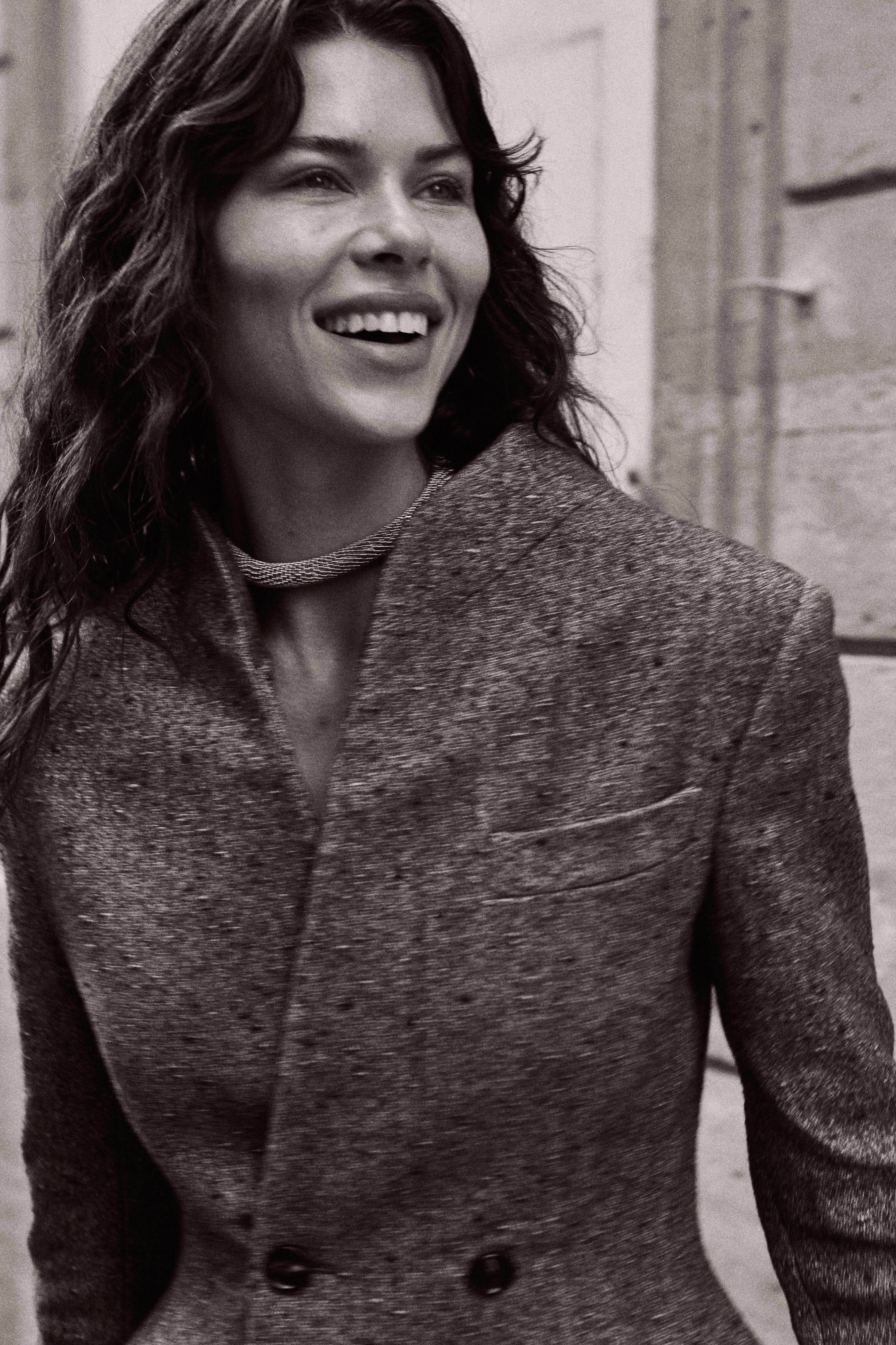 Model smiling in tweed blazer