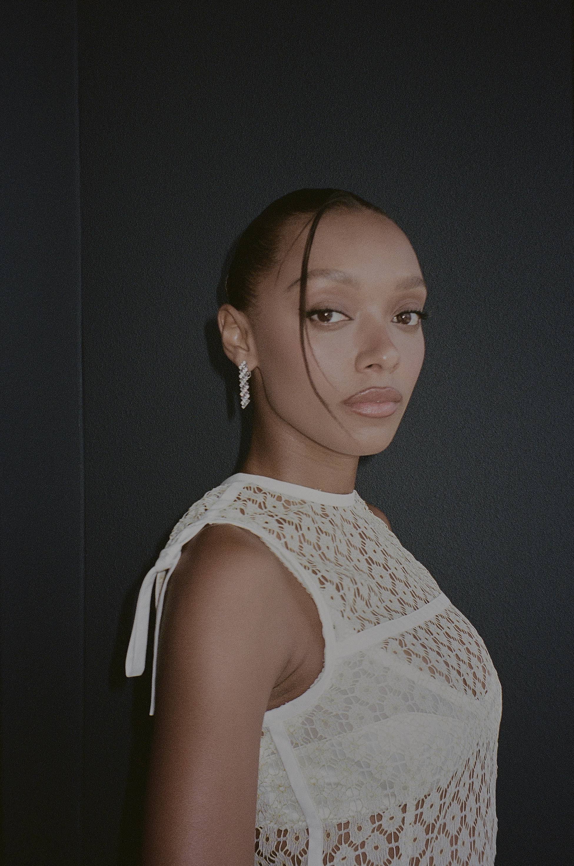 Model in white lace top diamond earrings