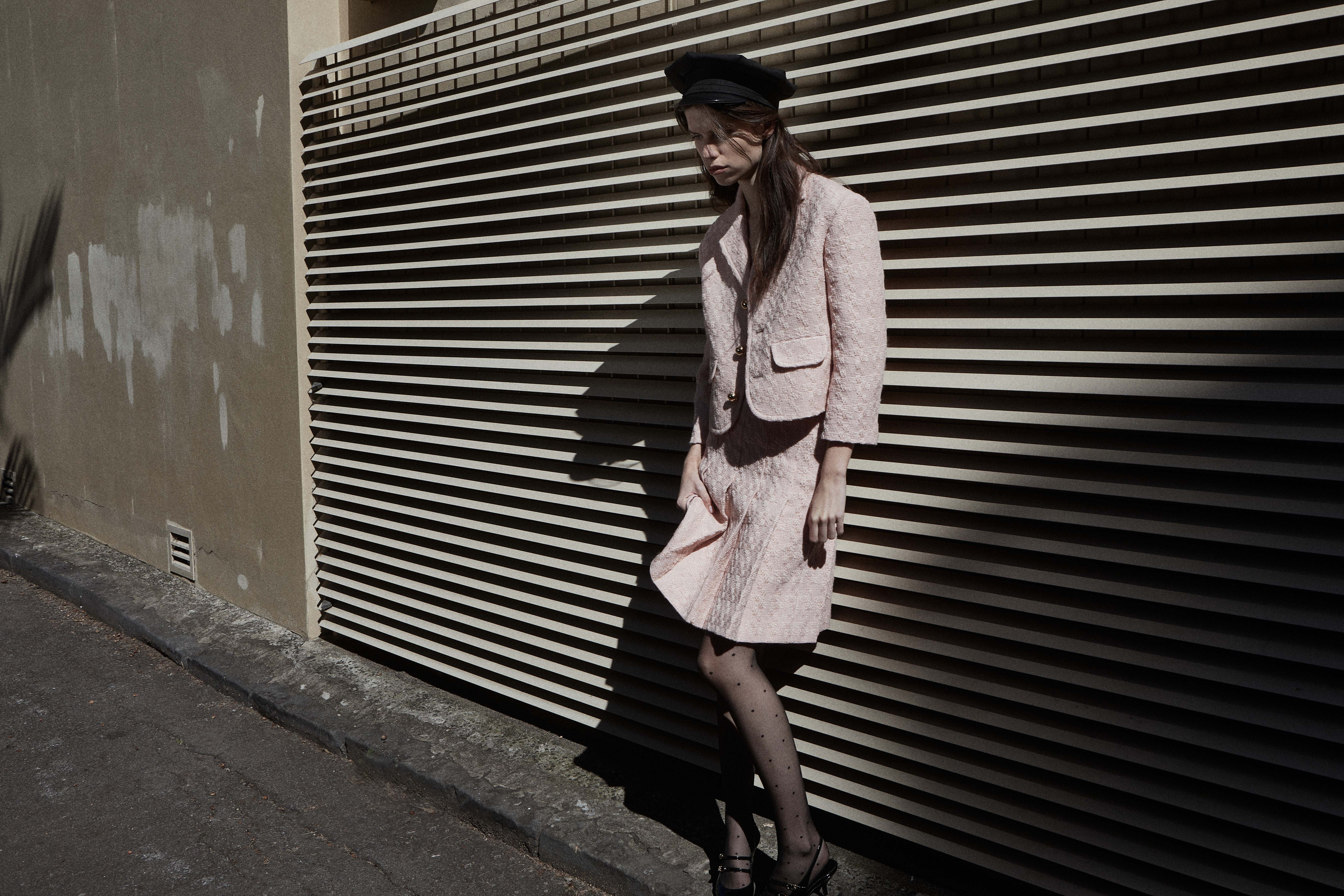 Model in pink tweed suit with hat