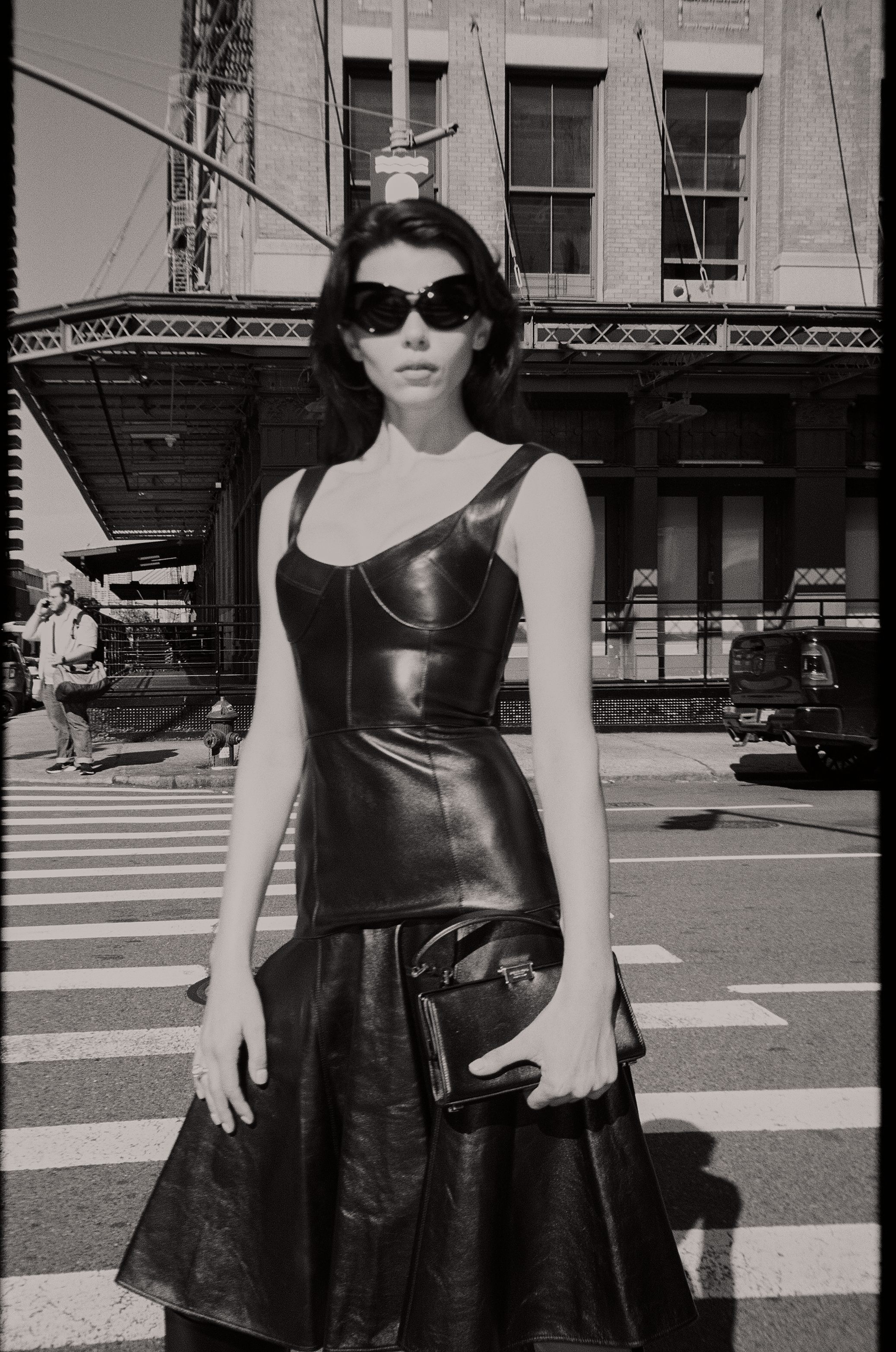 Black and white NYC model in leather dress elevated train