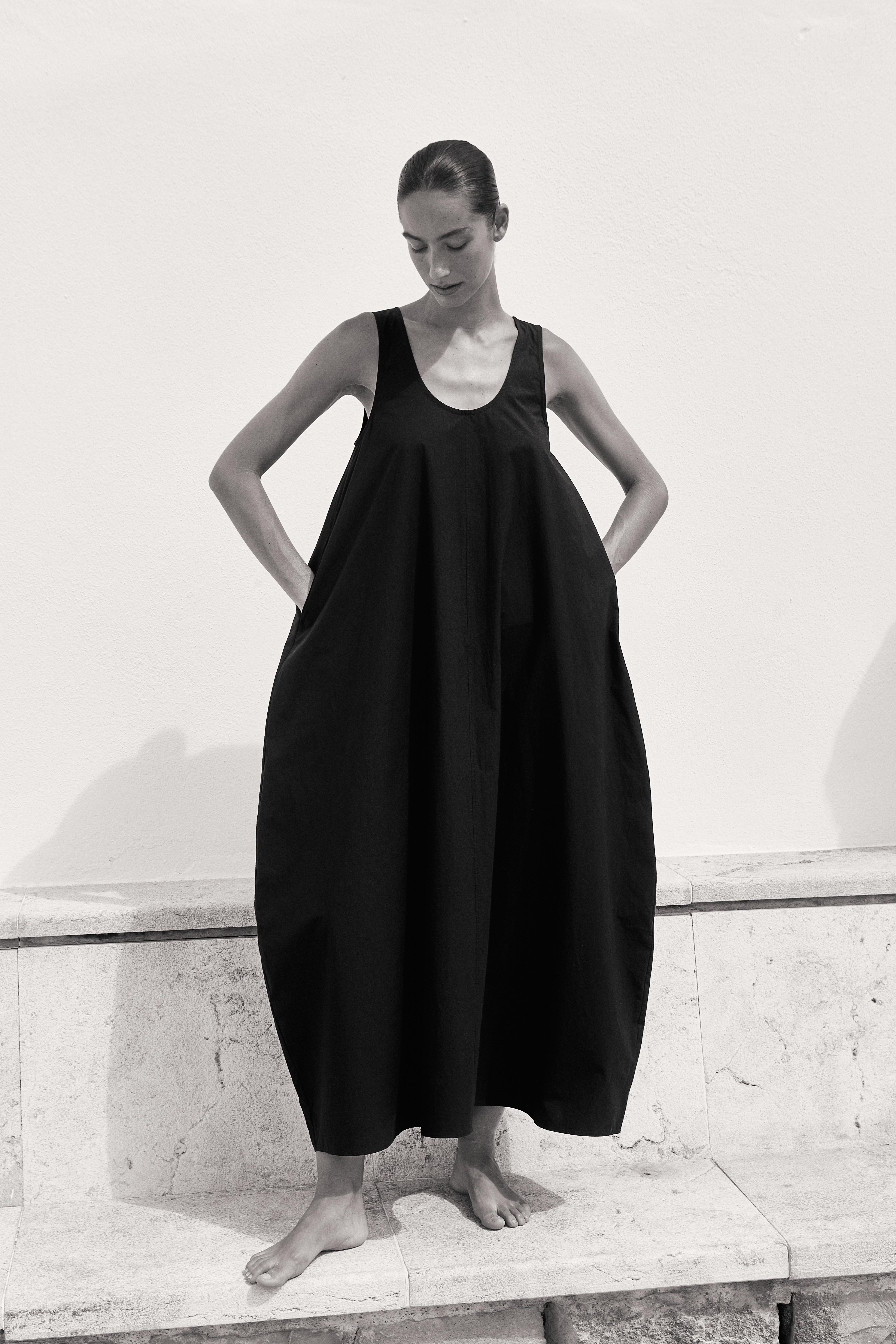 Black and white model in black oversized dress marble