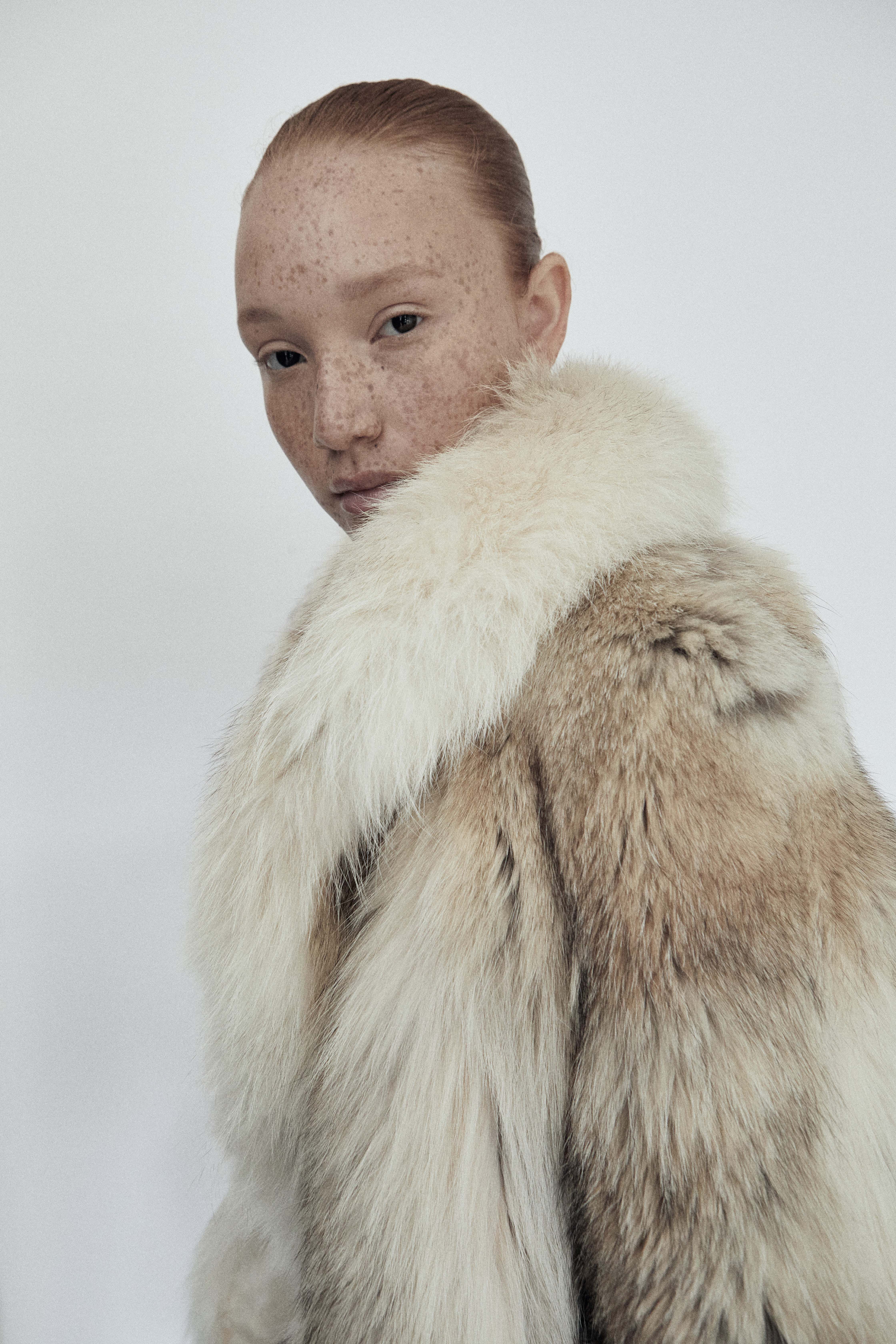 Freckled redhead model in fur coat